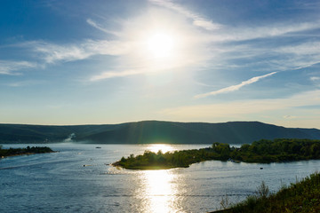 Bright sun reflected in the river, the landscape ,summer sky.