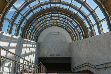 descent into the subway. A wide staircase and a glass roof in the form of  arch