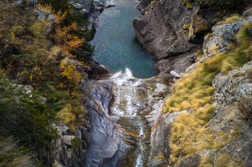 blue pond at the bottom of the waterfall, mountain landscape, long exposure silky water