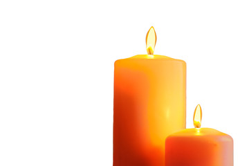 Two orange burning candles on white background