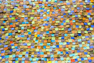 Wall decorated with mosaic tiles and colored bricks Photo execut