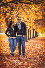 Young couple hiking in the park at autumn
