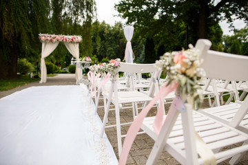 Wedding background. Decorations, chairs and wedding arch at the wedding ceremony