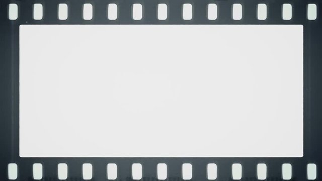 Film reel moves horizontally with empty frame in the middle.