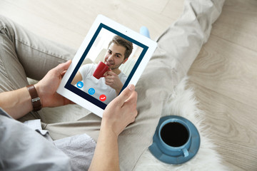 Video call and chat concept. Modern communication technology. Man video conferencing on tablet.