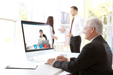 Man video conferencing with lawyer on computer. Video call and online service concept.