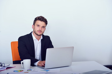 Businessman using laptop in modern startup office