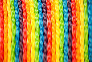background of rainbow twisted candy. colorful twisted licorice candy, texture