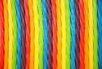 Garden poster Sweets background of rainbow twisted candy. colorful twisted licorice candy, texture