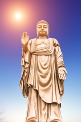 Fototapeta premium Buddha statue on the blue sky