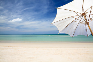 Umbrella and wood table on the beach