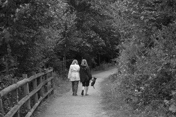 Two Women Walking Down Dirt Path in Ludlow, England