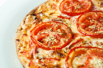 136413 ready pizza with tomatoes close up