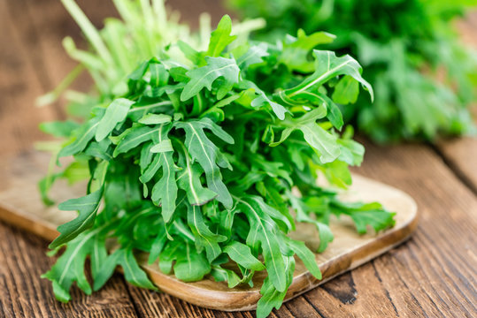 Fresh Arugula on an old wooden table