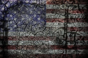 Faded american flag painting on cracked wall