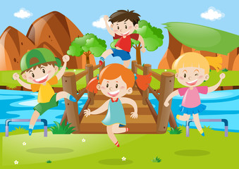 Obraz na płótnie Canvas Children crossing wooden bridge