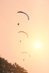 Paramotor fly in sunset sky