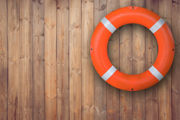 Life buoy hanging on wooden wall for emergency respone when people sinking to weter almost place...
