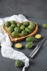 feijoa. fresh tropical fruits on the table. green fruits in thewooden plate. 