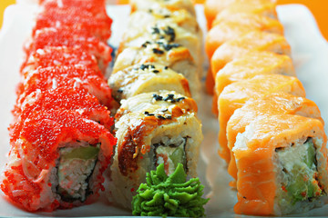 Different sushi rolls and wasabi closeup