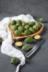 feijoa. fresh tropical fruits on the table. green fruits in thewooden plate. 