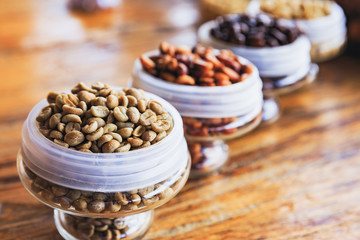 Various coffee beans on wooden background.