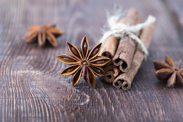 cinnamon and star anise on a wooden background . close-up