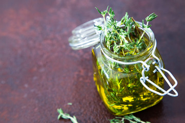 Thyme oil. Thyme essential oil jar glass bottle and branches of