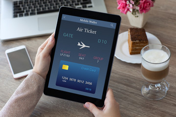woman hands holding tablet computer PC with air ticket