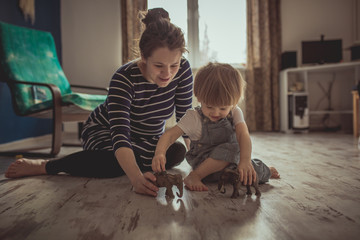 young pregnant mother and son playing on floor, lifestyle,