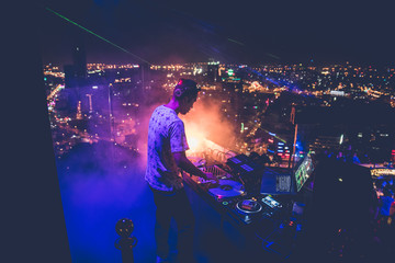 Fototapeta na wymiar DJ - Party on top of building with music entertainment