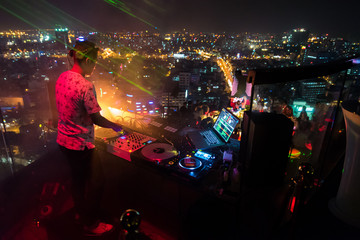 Fototapeta na wymiar DJ - Party on top of building with music entertainment