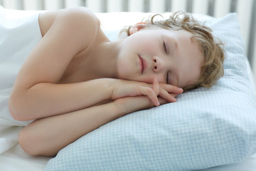 Fototapeta na wymiar Sweet child sleeping in bed.
