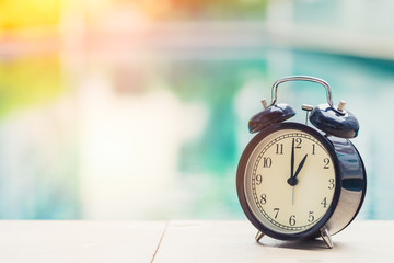 1 o'clock retro clock at the swimming pool outdoor holiday time concept.