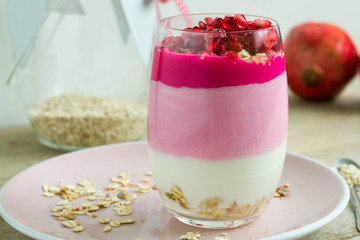 Parfait with muesli, natural yogurt, fruit yogurt and pomegranate.