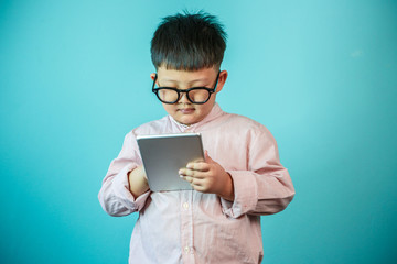 Boy on tablet pc on the blue background