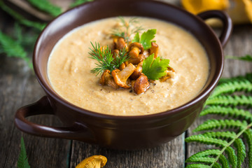 chanterelle cream soup on wooden background