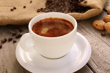 Cup of hot coffee on wooden surface