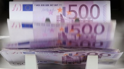 Cash money counting machine. Banknote counter are counting five hundred euro bills.