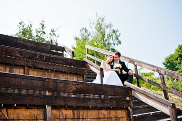 wedding couple on wooden stairs