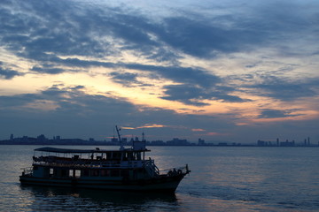 Silhouette of a passenger ferry boat during sunset