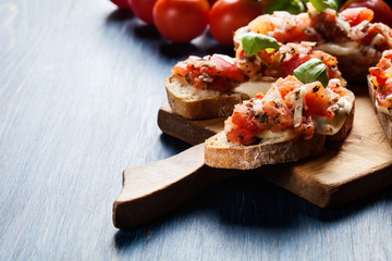 Italian bruschetta with roasted tomatoes, mozzarella cheese and