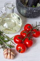 tomato with olive oil on wooden background