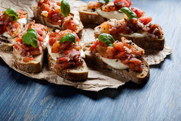 Italian bruschetta with roasted tomatoes, mozzarella cheese and