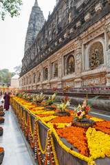 Garlands with flowers and festive bouquets at Mahabodhi Temple, in commemoration of day of an enlightenment of Buddha Shakyamuni and Buddhist New Year.