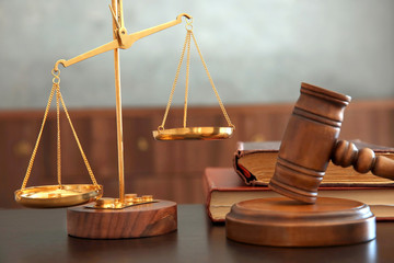 Justice scales, judges gavel and books on wooden table
