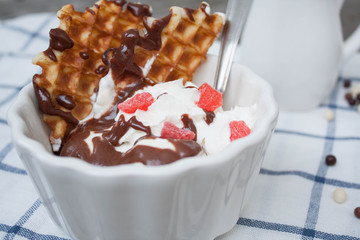 banana split with ice cream, chocolate, whipped cream and waffles. classic yummy baby dessert.