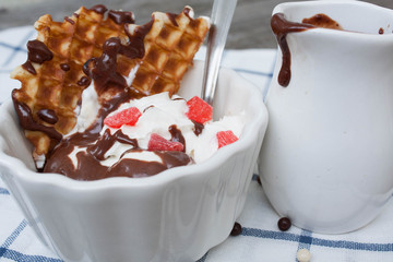 banana split with ice cream, chocolate, whipped cream and waffles. classic yummy baby dessert.