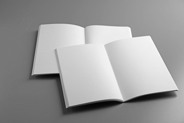 Blank open brochures on grey background