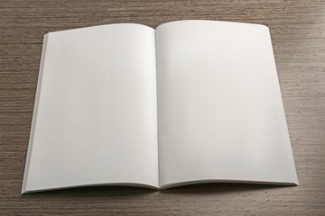 Blank open brochure on wooden background